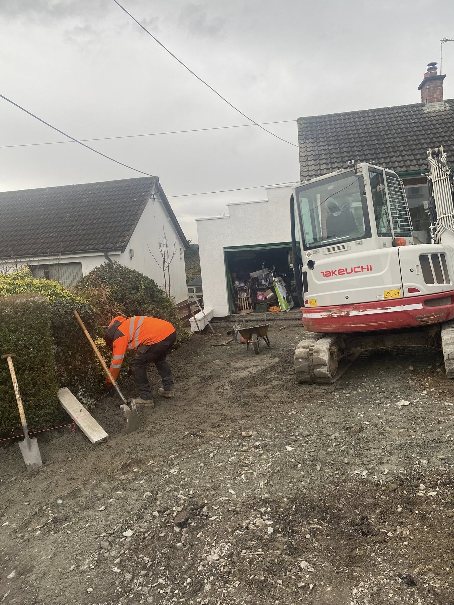 Groundworkers levelling and preparing a construction site