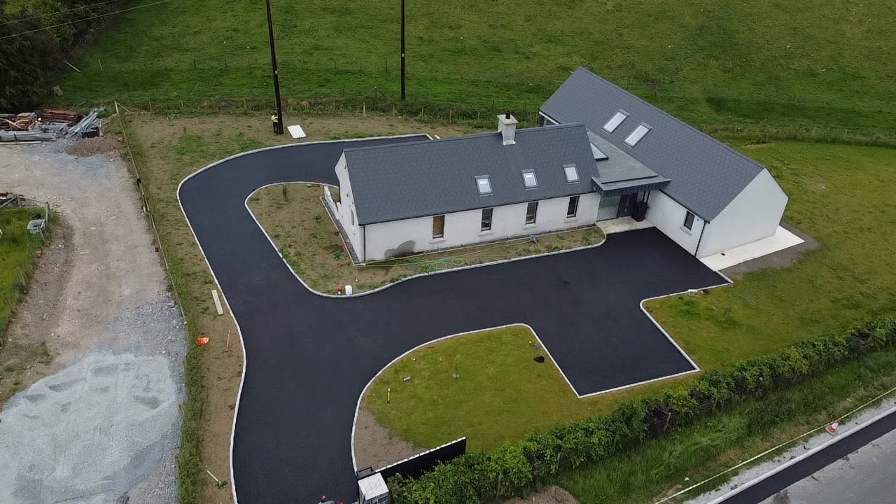Freshly surfaced tarmac driveway outside a property